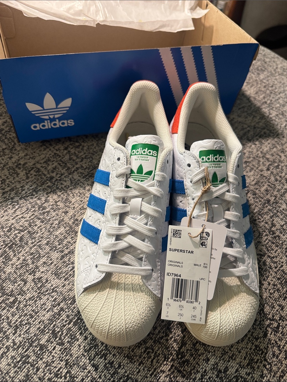 Adidas White Superstar sneaker with Blue Stripes, Green Logo and Red Heel Tab